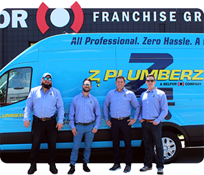 employees posing in front of work van