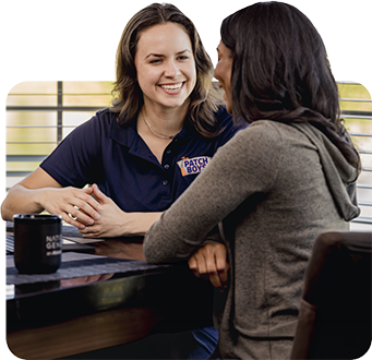 customer sitting at desk with employee