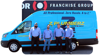 employees posing in front of work van